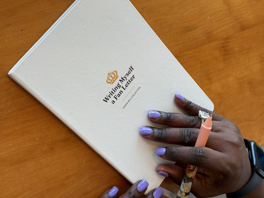 The white Writing Myself a Fan Letter journal on a wood table