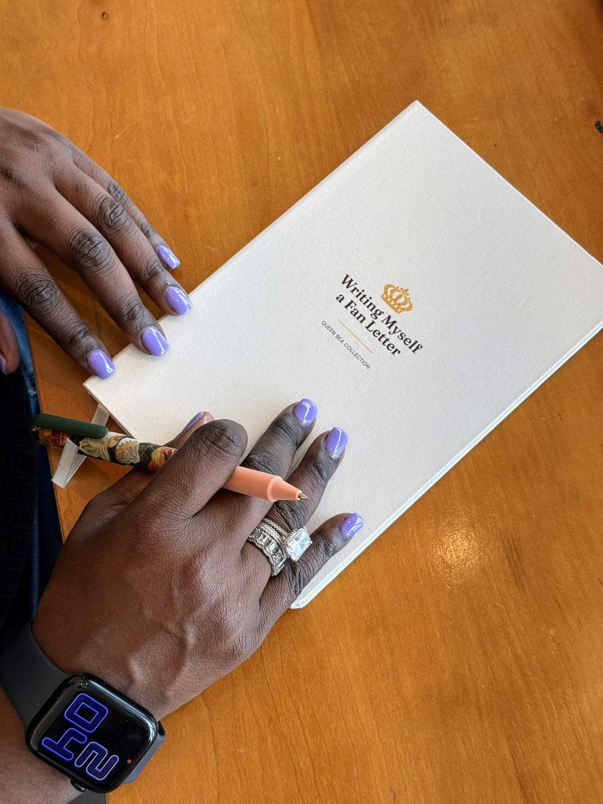 The white Writing Myself a Fan Letter journal held in both hands, gold title legible