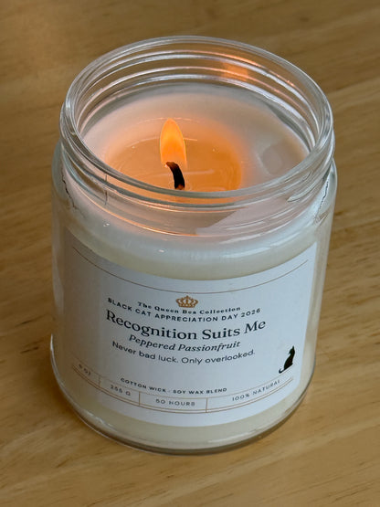 Recognition Suits Me candle lit, showing the melted soy wax and cotton wick