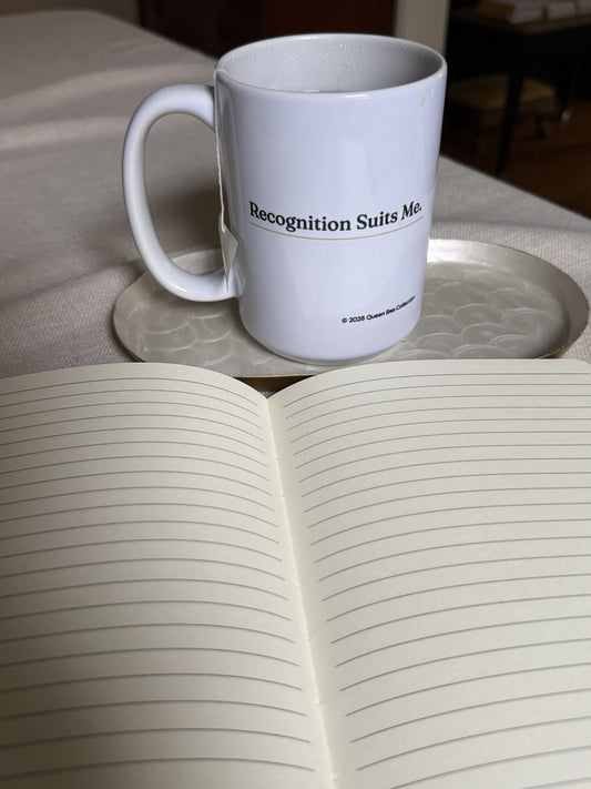 Recognition Suits Me mug beside an open journal with lined pages