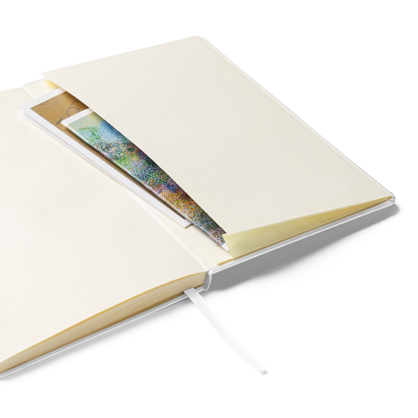 The Writing Myself a Fan Letter journal open to its cream lined pages, showing the ribbon marker and the expandable inner pocket