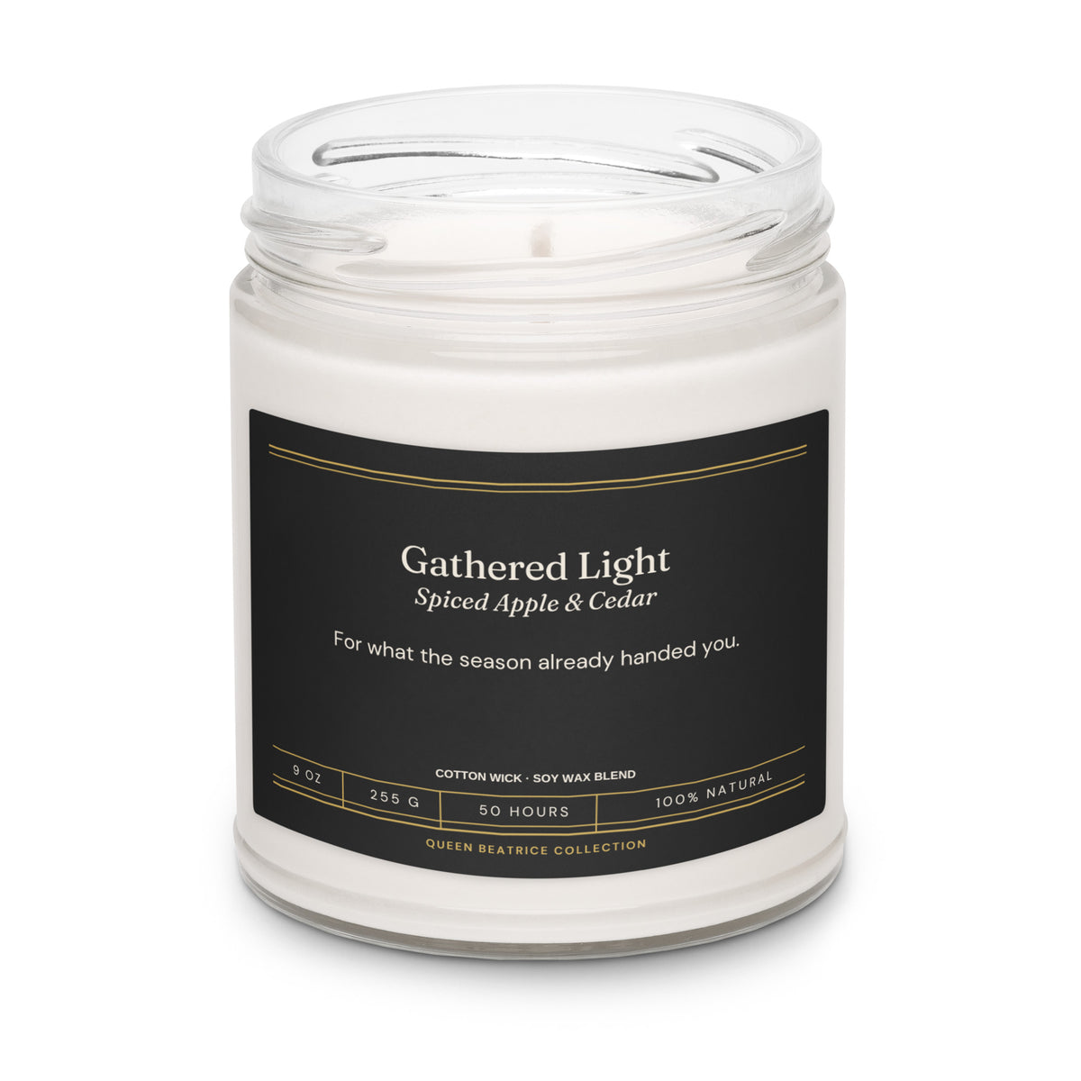 Gathered Light soy candle in a glass jar with the black Ember & Intention label, Spiced Apple & Cedar
