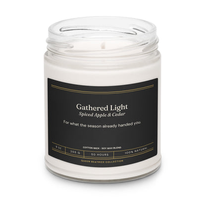 Gathered Light soy candle in a glass jar with the black Ember & Intention label, Spiced Apple & Cedar